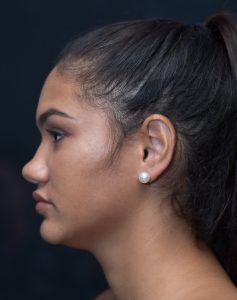 Model wearing small stud earrings